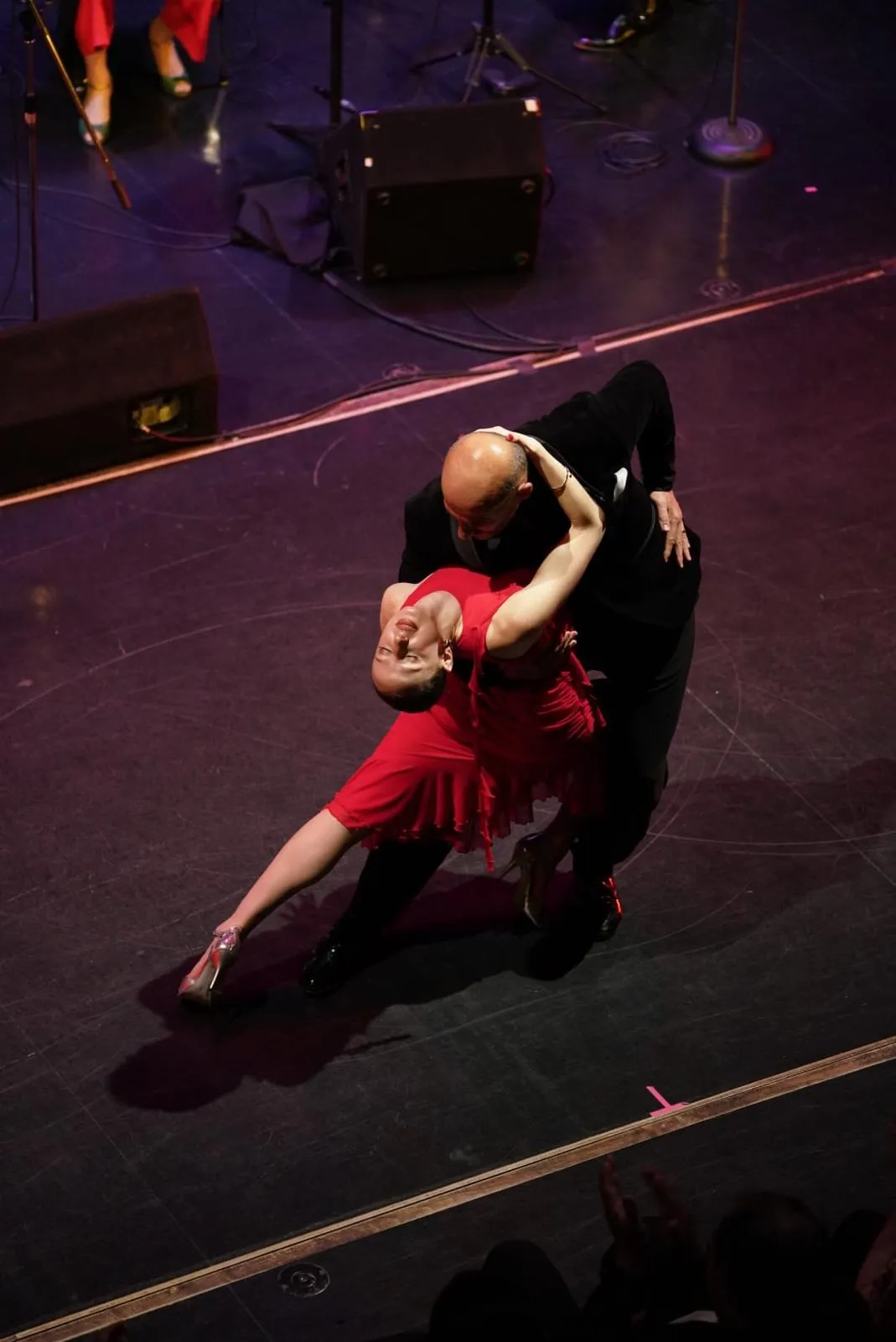 Esti Spivakov performing a dramatic Argentine Tango dip on stage with a partner