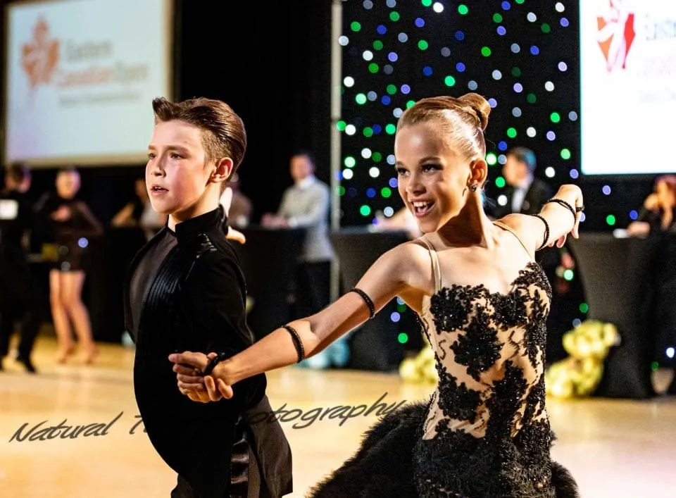 Two young dancers performing a Latin routine at a competition