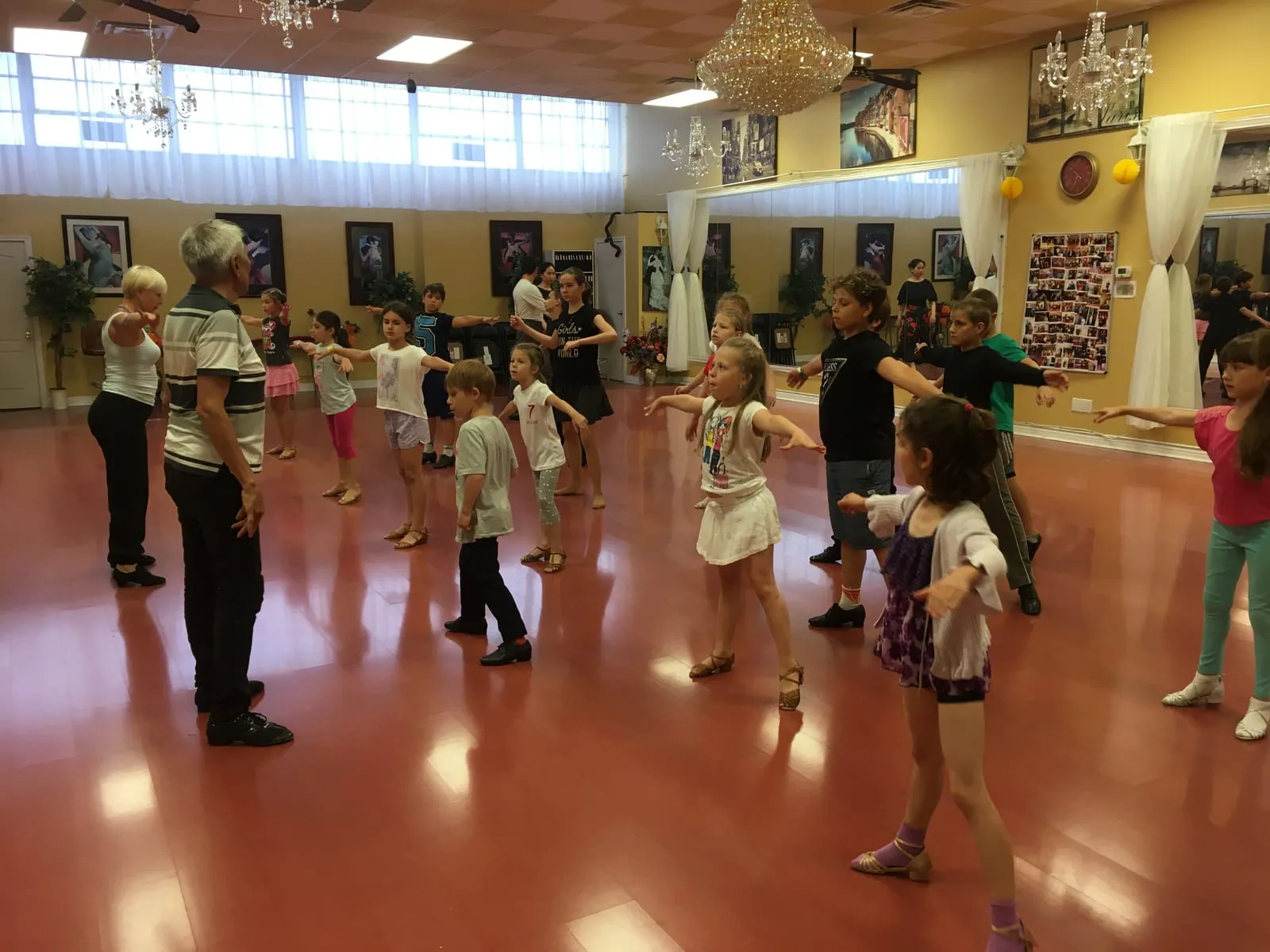 Children practising arm positions in a group class