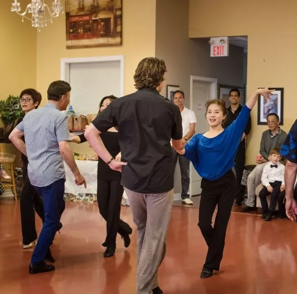 Adult group class practising a Latin routine in the studio