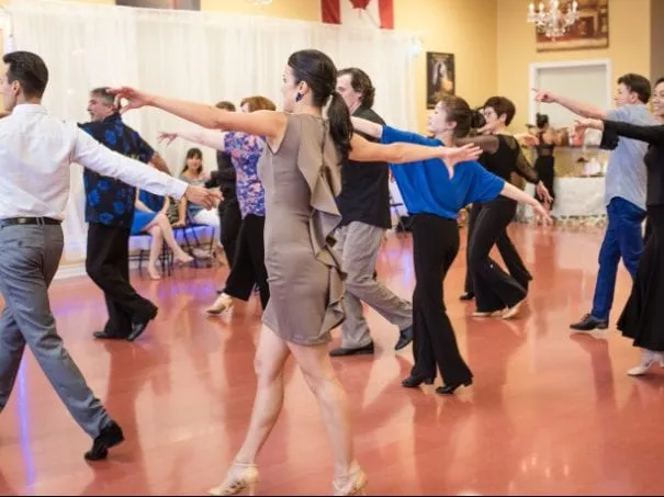 A room of adult students practising a routine together