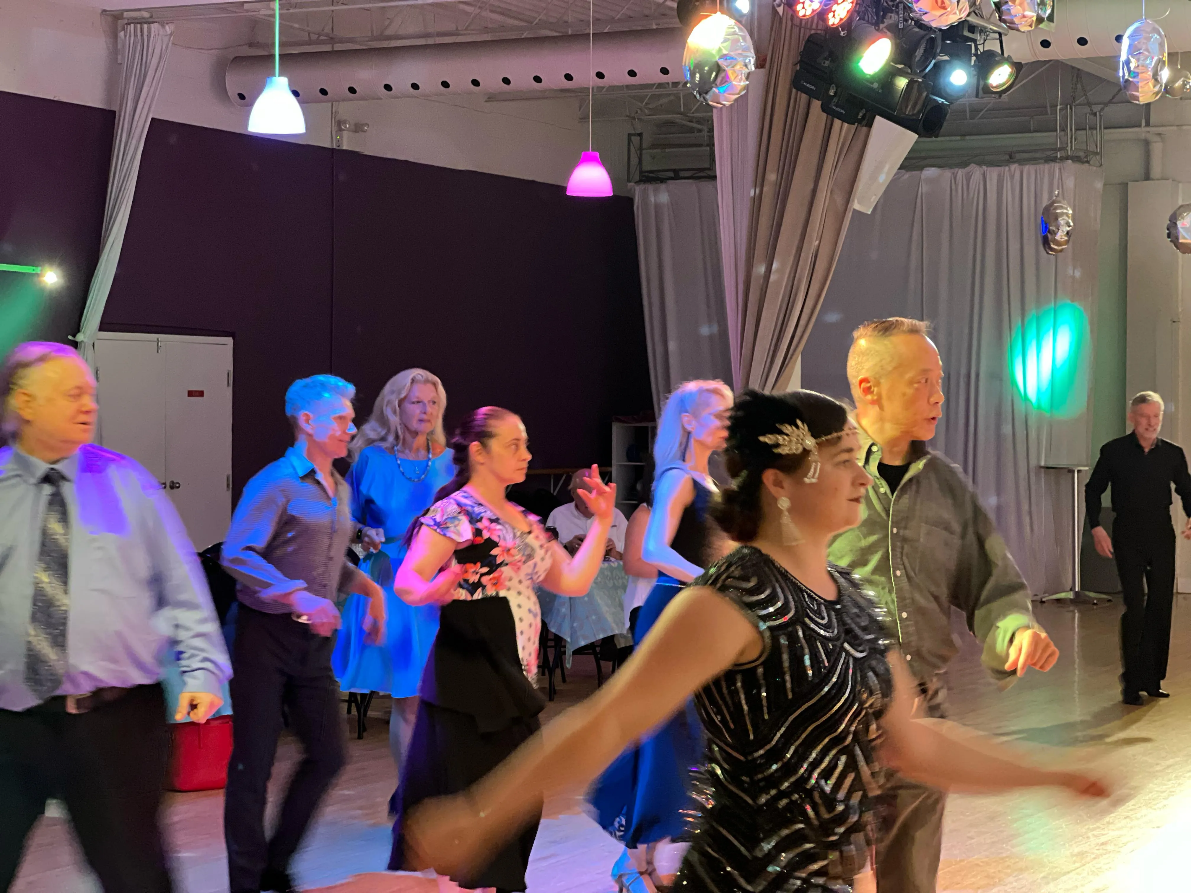 Adults social dancing together at an evening studio outing