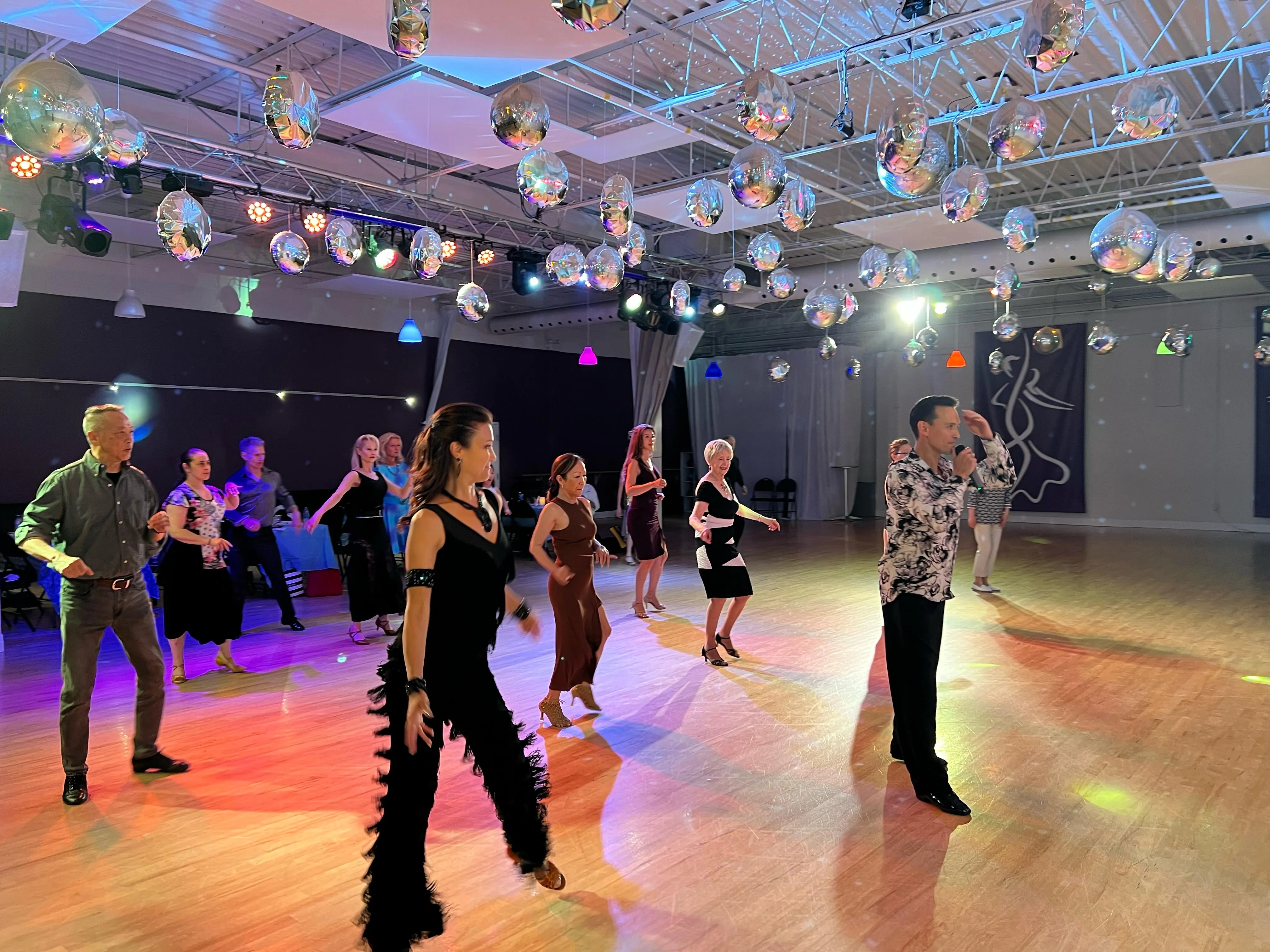 A group of adults dancing together at a social night