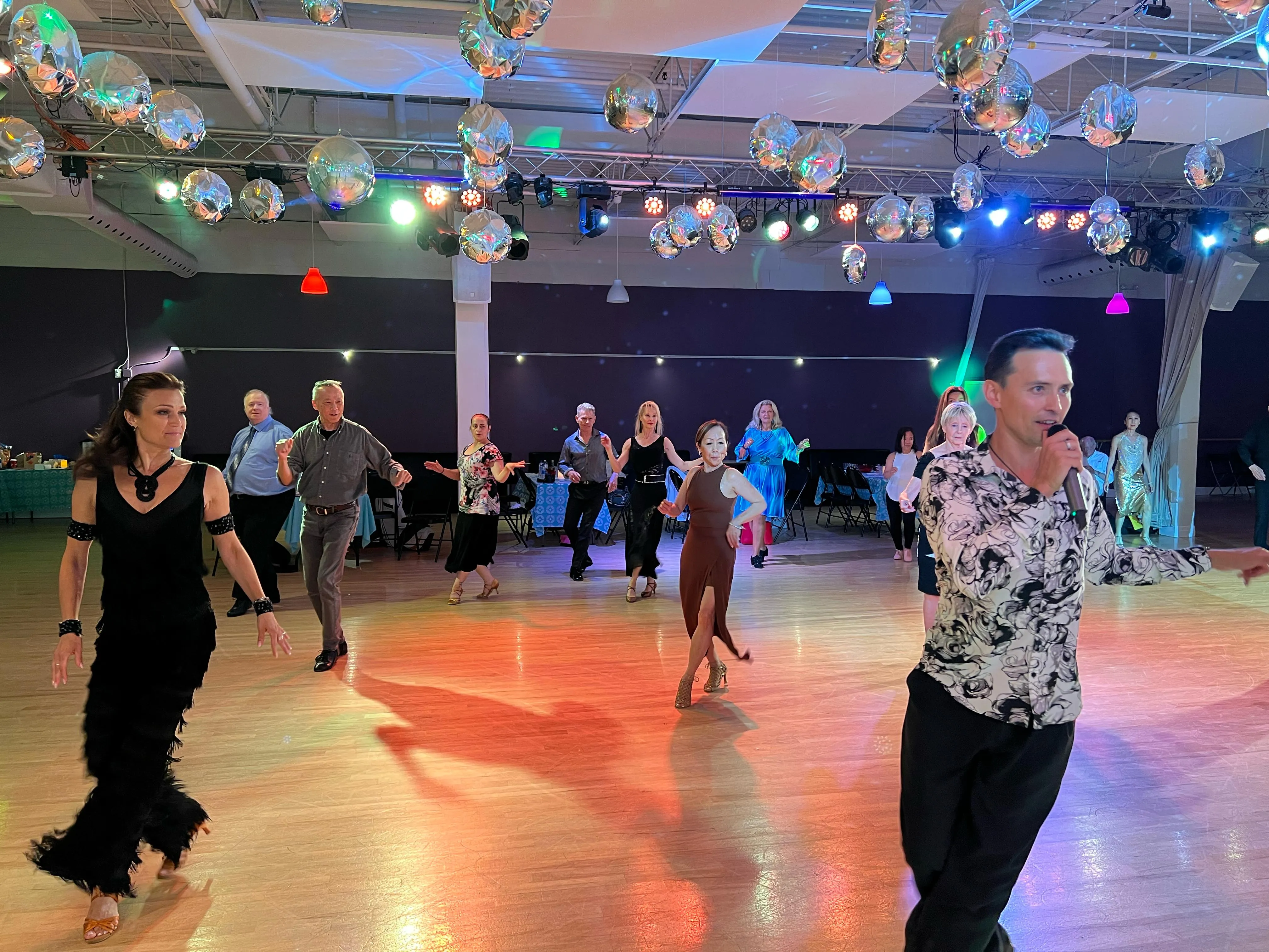 Adults dancing together at a studio social event